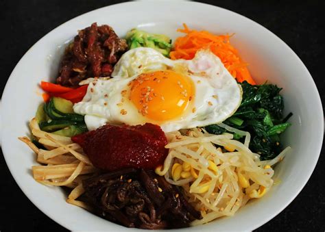 Place the pear, and cucumber on top of the noodles. . Maangchi bibimbap